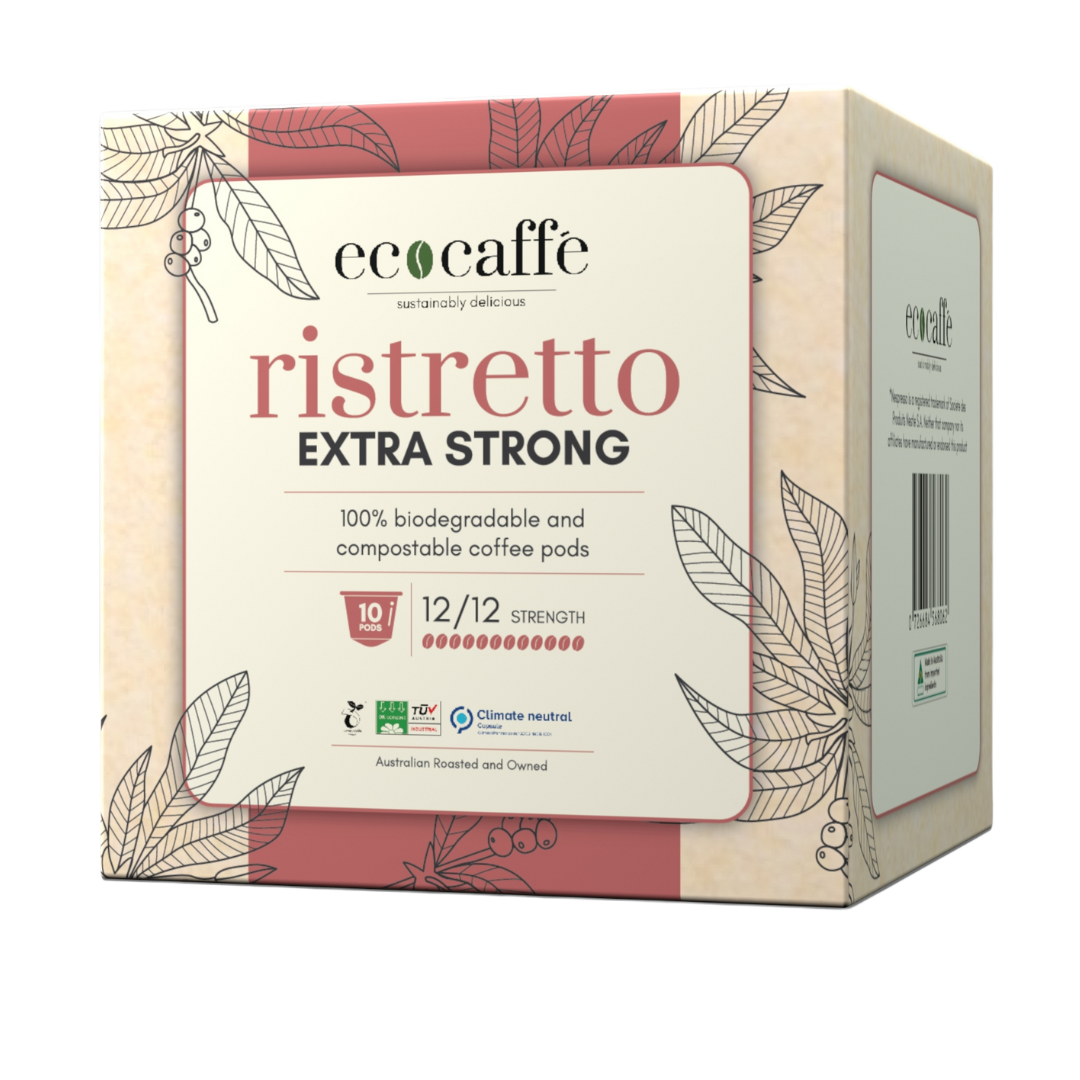 A box of compostable coffee pods labeled 'ristretto extra strong' from the brand ecocaffe. The packaging is adorned with leaf patterns and indicates the product is compostable, with a strength rating of 12.